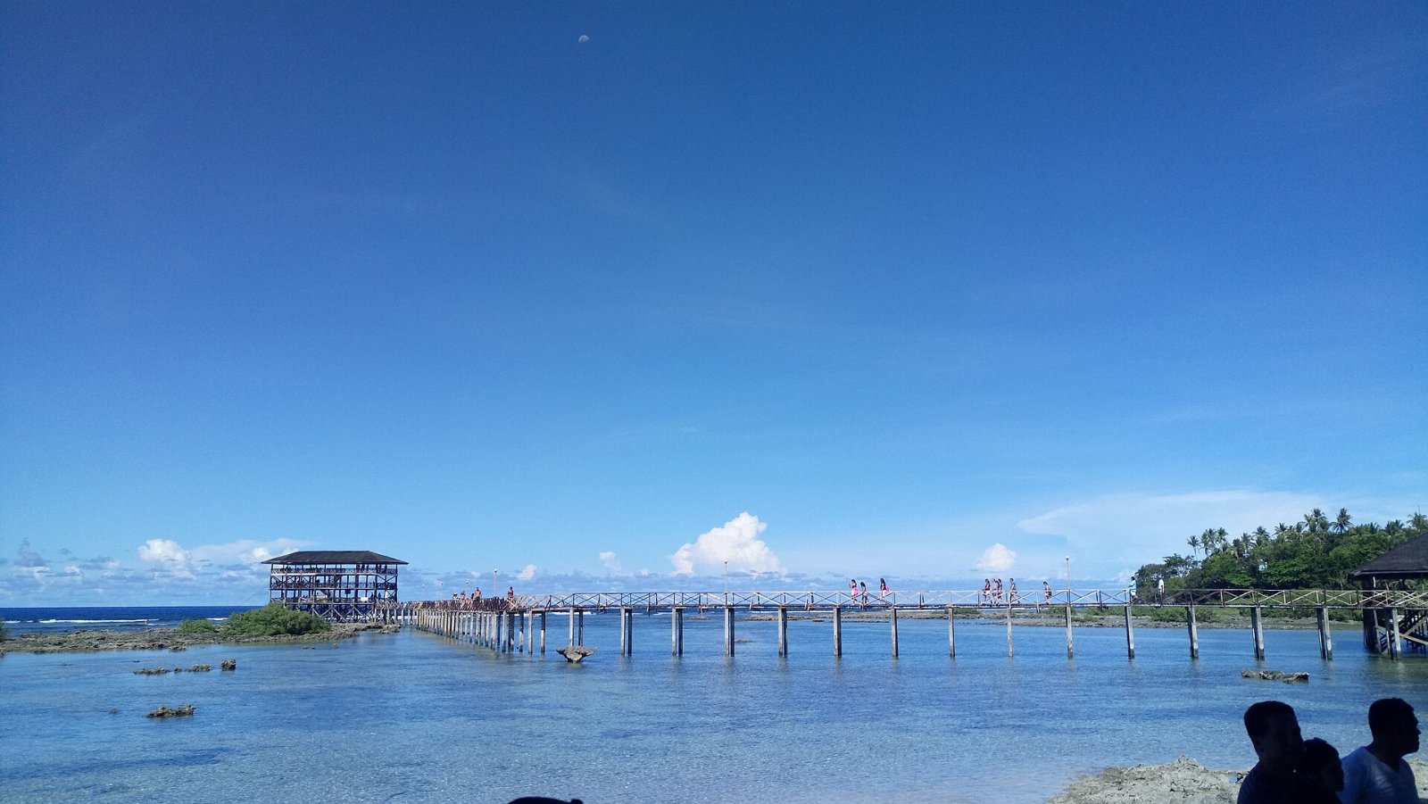 Surfer and beach scenery in Siargao, Philippines