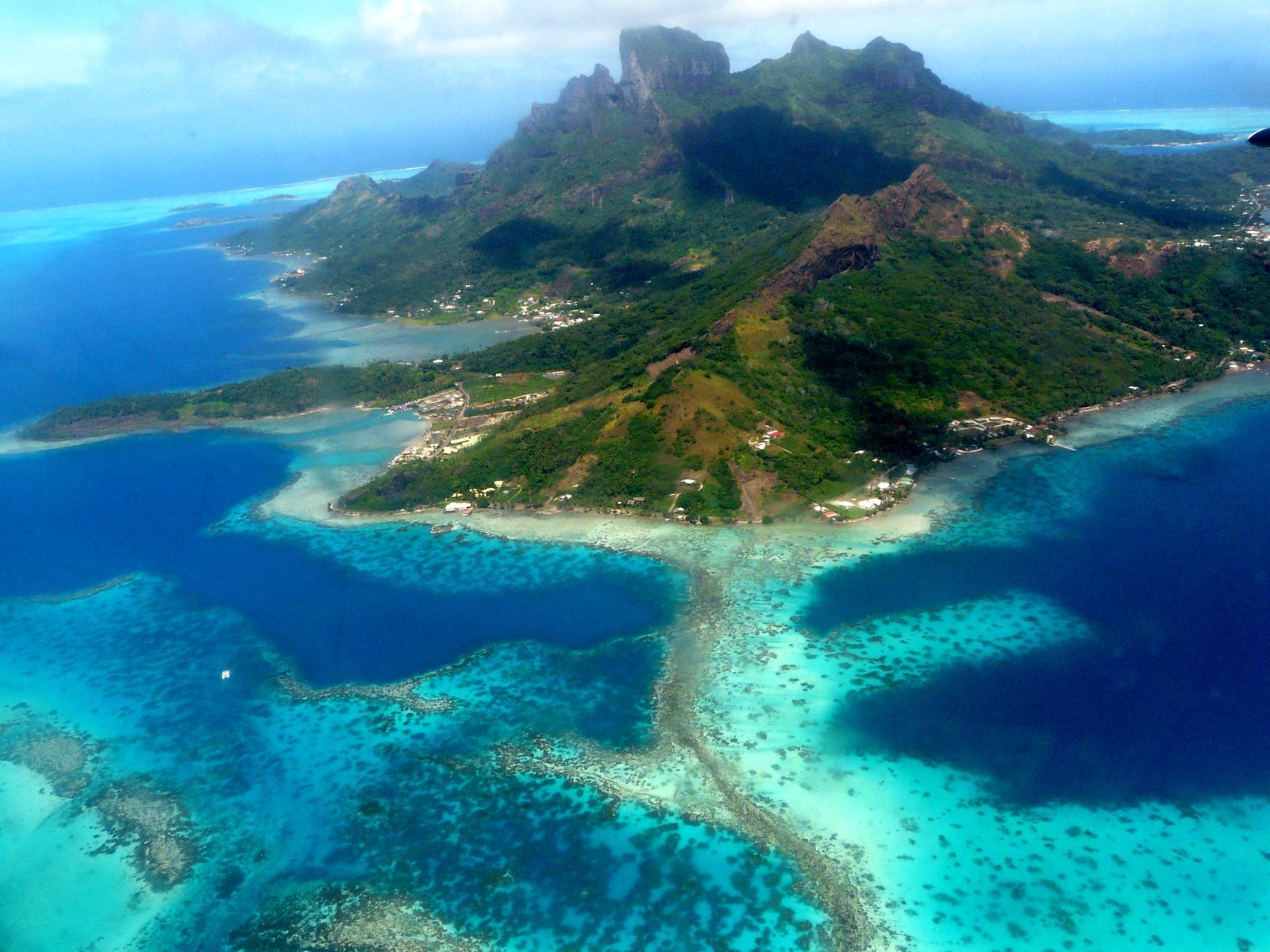 Overwater bungalow resort in Bora Bora lagoon at sunset