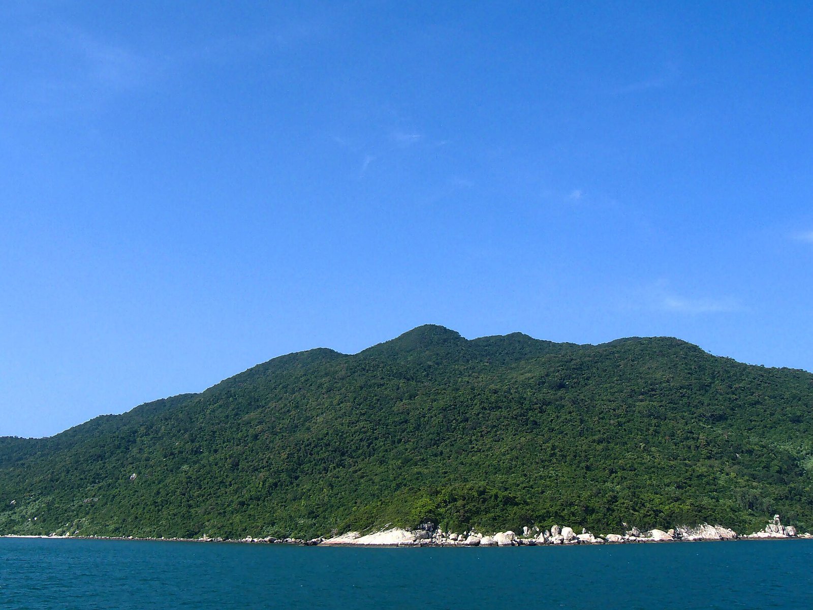 Clear water and green hills at Cu Lao Cham Marine Park off Hoi An, Vietnam