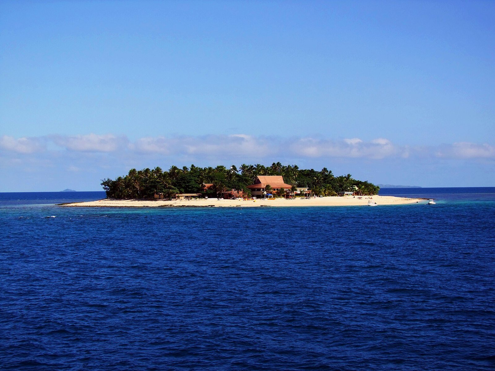 Small island with white sand beach and turquoise reef in the Mamanuca Islands, Fiji