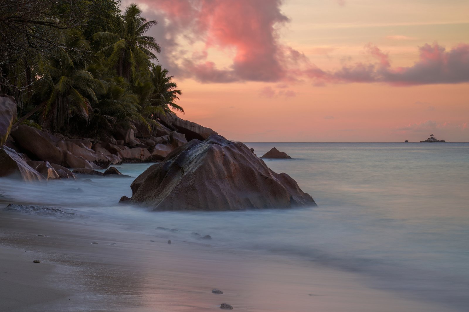 Granite boulders on a beach in La Digue, Seychelles at sunset